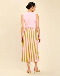 Woman wearing the Mestiza Joyah Midi Skirt in Herbes de Provence print, featuring a wrap-style silhouette, A-line shape, scalloped trim detailing, and cotton poplin fabrication.