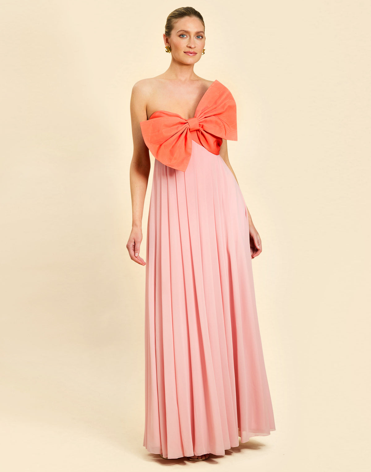 Kiss Me Knot Gown in Bloom Pink chiffon with oversized bow neckline, strapless silhouette, and flowing skirt.