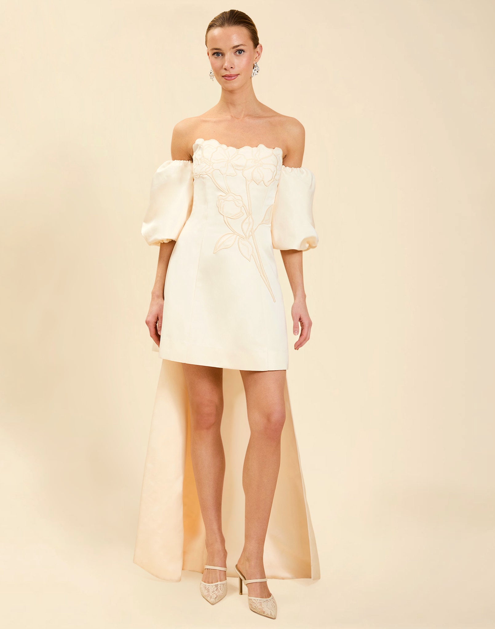 Liezel Convertible Mini Dress in Ivory taffeta with tonal floral embroidery, removable balloon sleeves, and detachable Watteau-style train.
