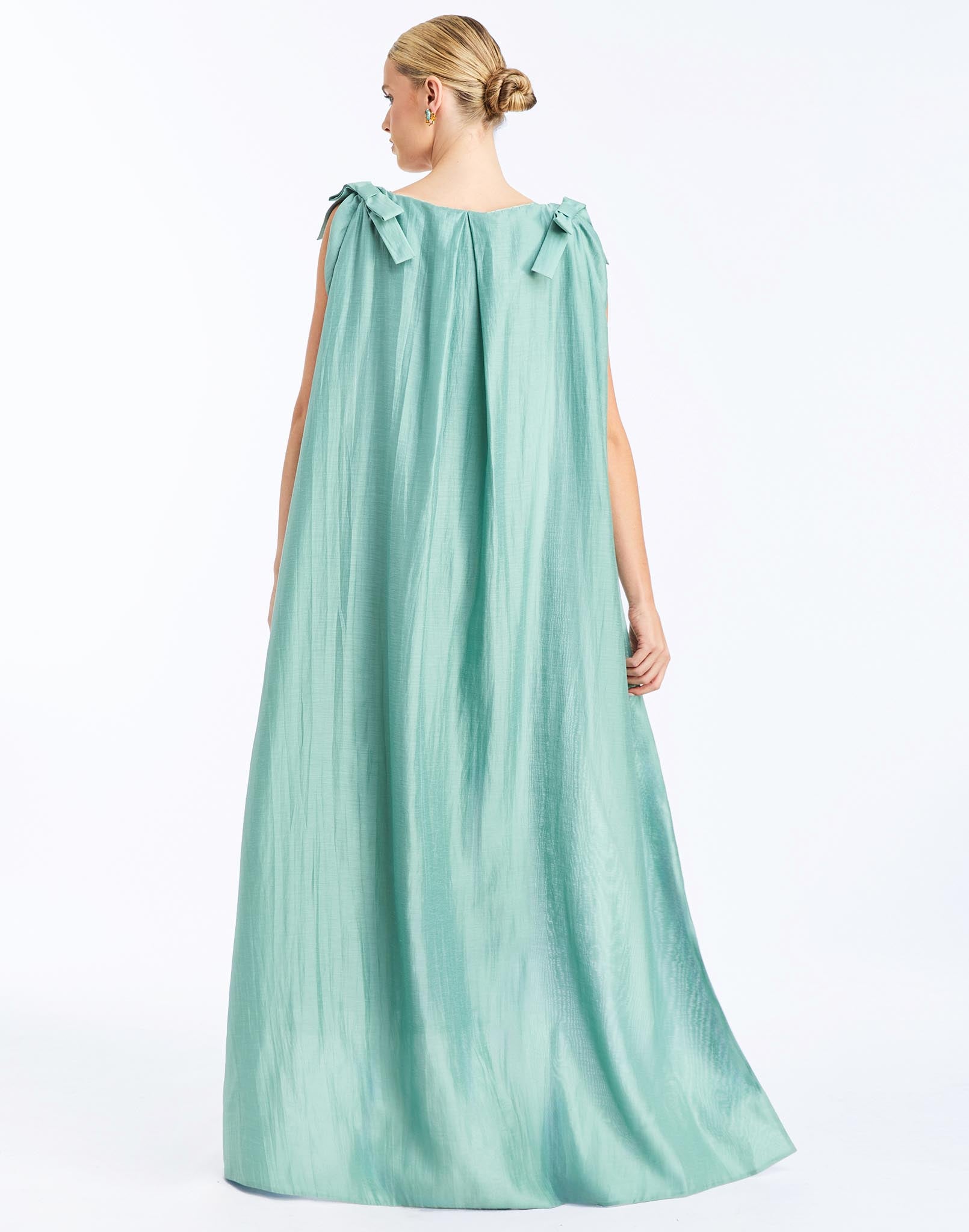 Back - Lillian Convertible Gown in Aquarelle Blue is a sequin column gown with removable cape and bow details.