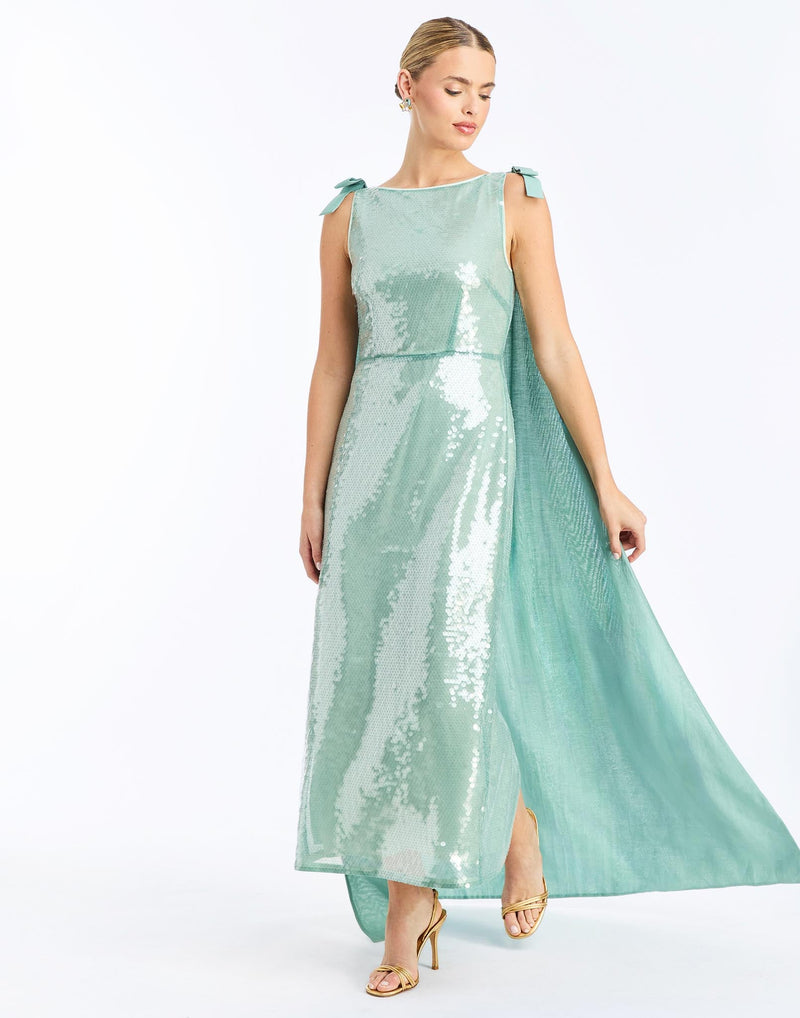 Front - Lillian Convertible Gown in Aquarelle Blue is a sequin column gown with removable cape and bow details.
