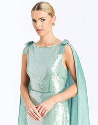 Detail - Lillian Convertible Gown in Aquarelle Blue is a sequin column gown with removable cape and bow details.