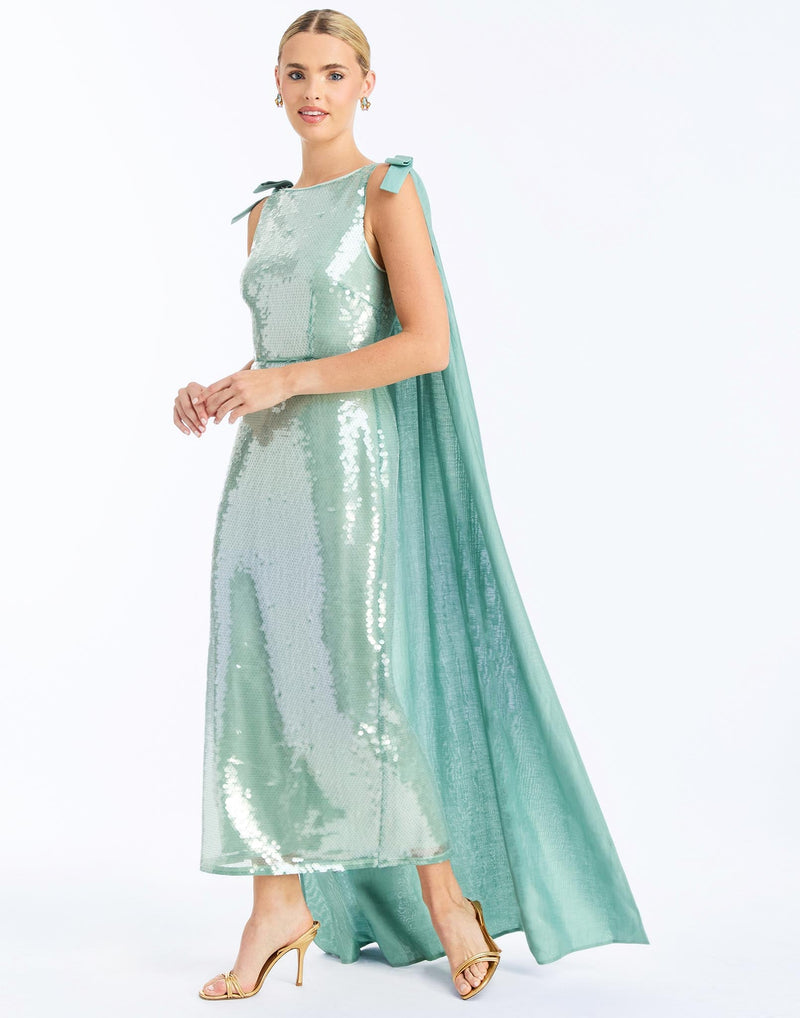Side - Lillian Convertible Gown in Aquarelle Blue is a sequin column gown with removable cape and bow details.