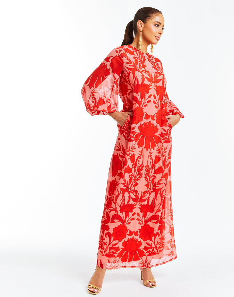 Arabesque printed maxi dress gown with sash tie at neck and blouson sleeves. 