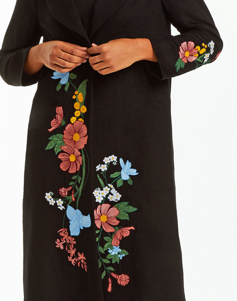 Black wool duster with floral embroidery.