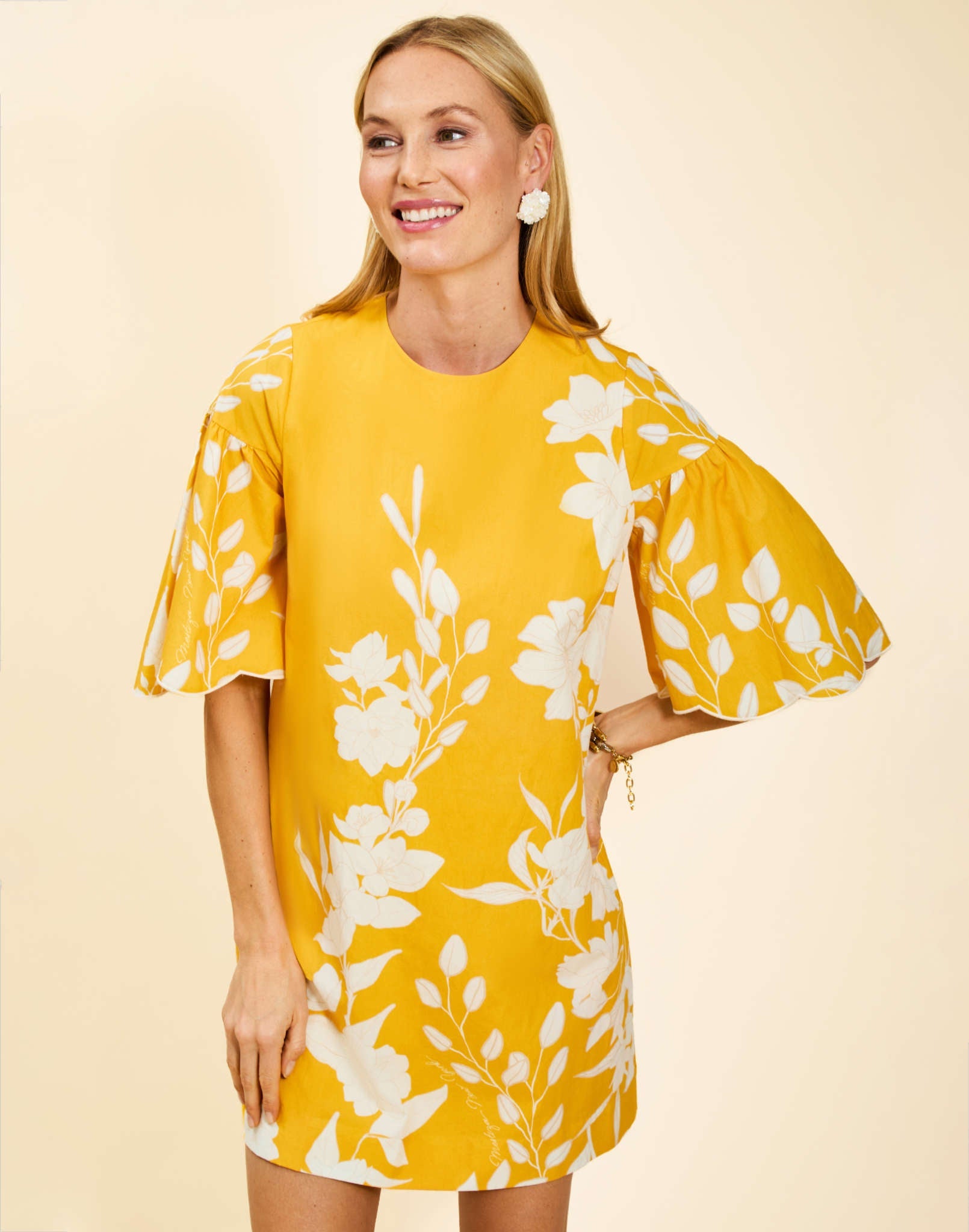 Marianna Shift Mini Dress in Huckleberry Yellow poplin with scalloped elbow-length sleeves, ruffle detail, and shift silhouette.