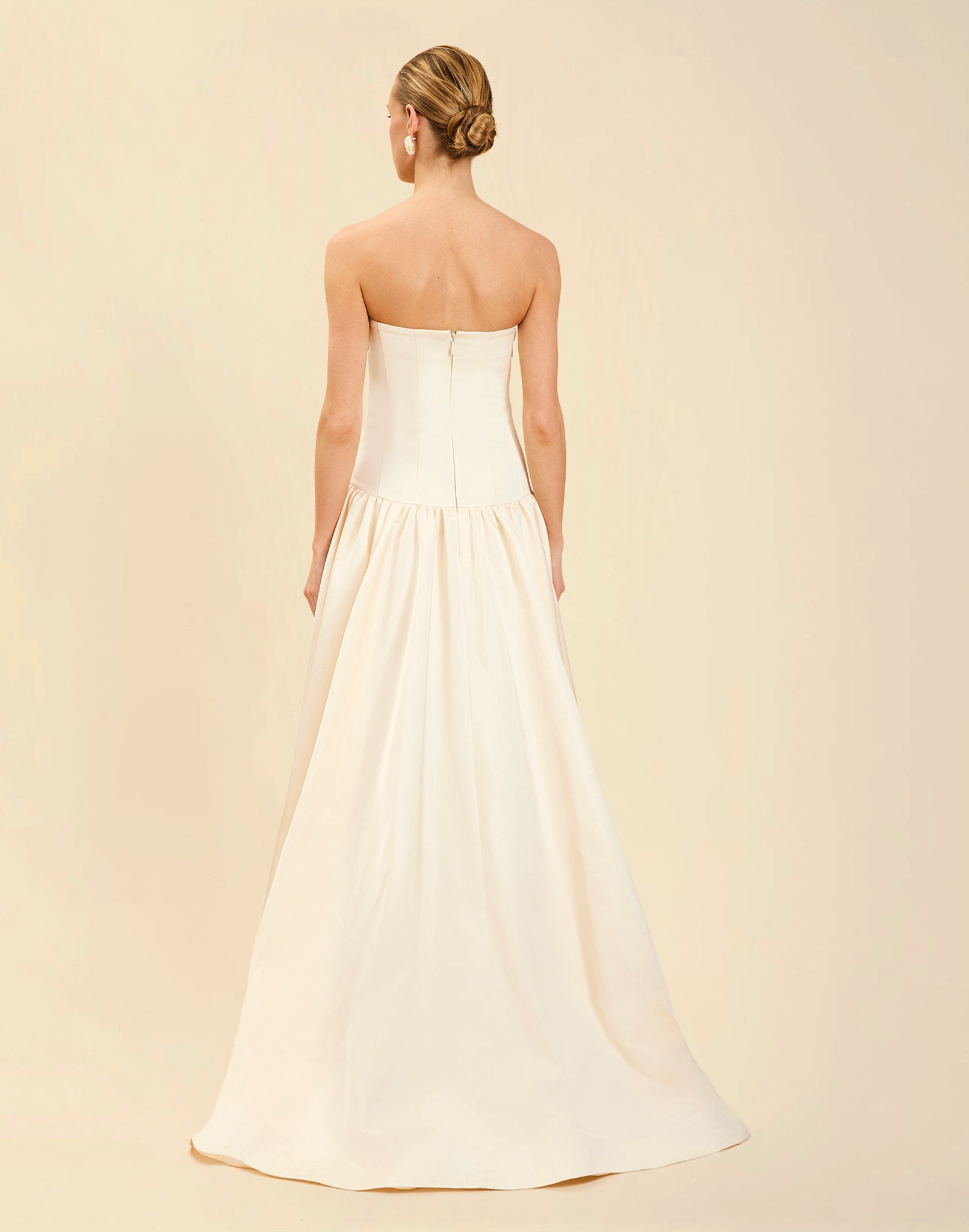 Nereida Dropwaist Gown in Ivory taffeta with strapless neckline, tonal floral embroidery, drop-waist silhouette, and high-low skirt with train.