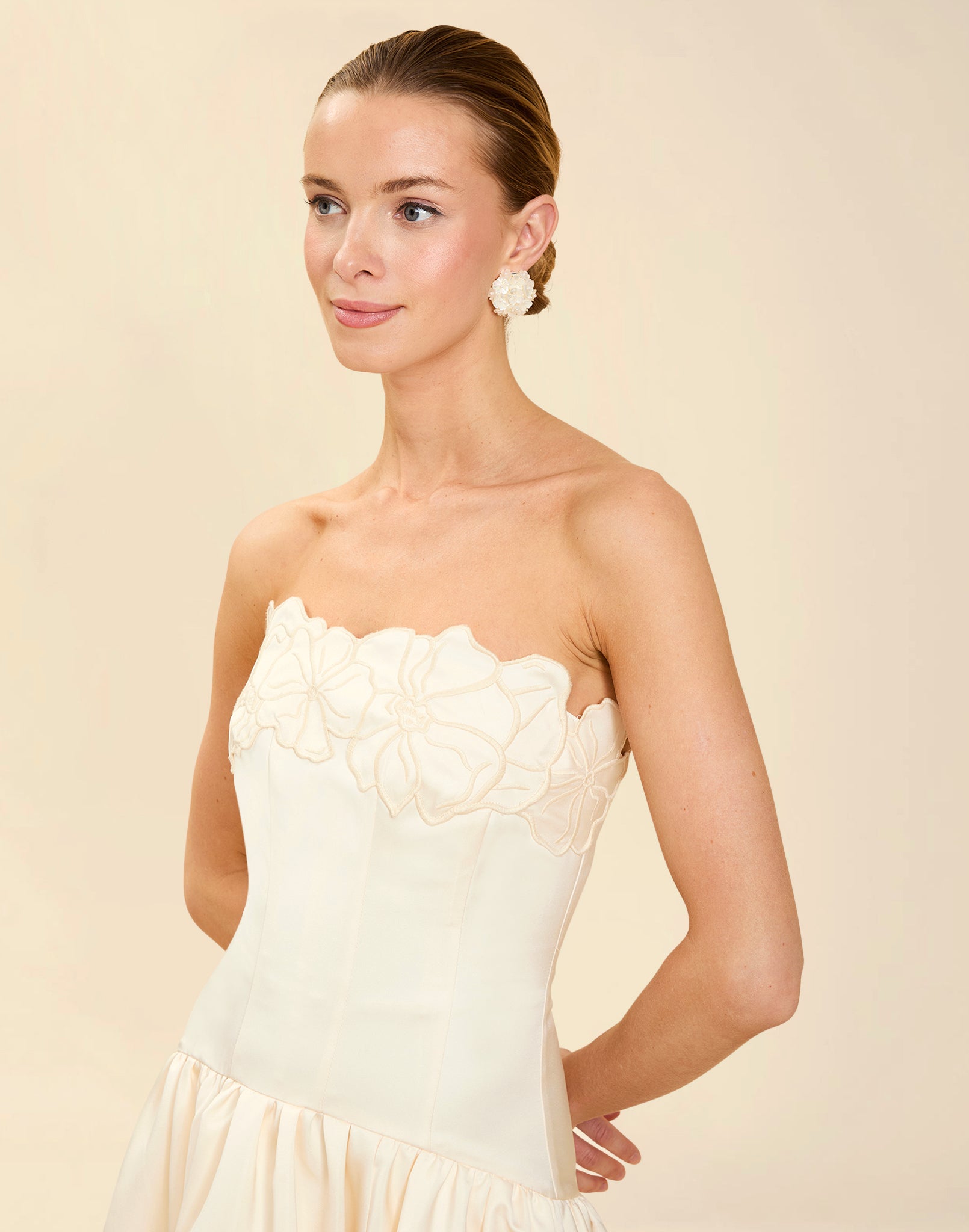 Nereida Dropwaist Gown in Ivory taffeta with strapless neckline, tonal floral embroidery, drop-waist silhouette, and high-low skirt with train.