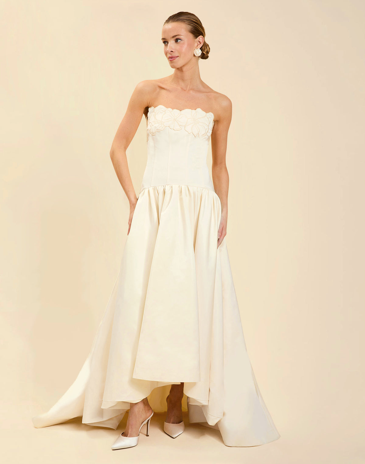 Nereida Dropwaist Gown in Ivory taffeta with strapless neckline, tonal floral embroidery, drop-waist silhouette, and high-low skirt with train.