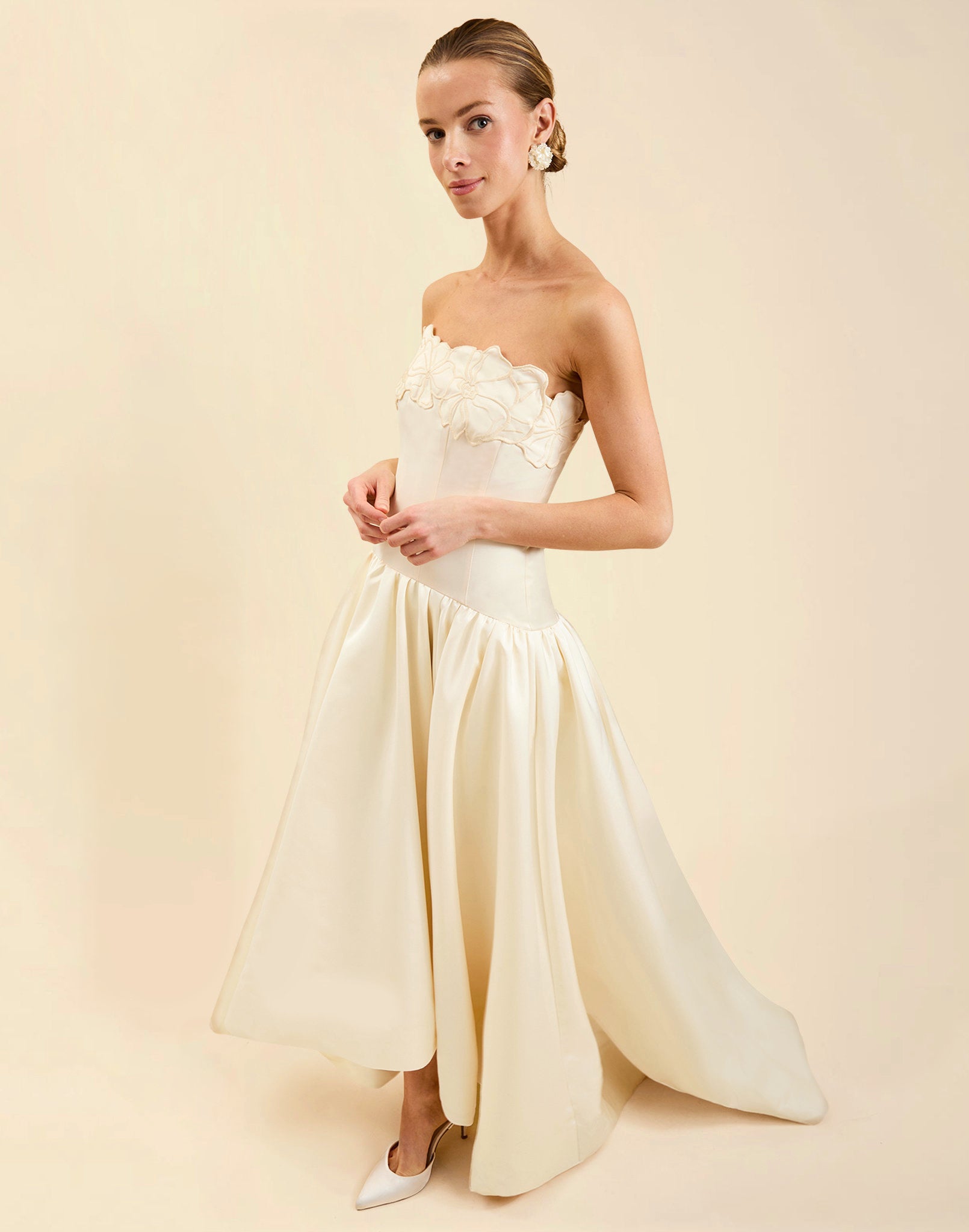 Nereida Dropwaist Gown in Ivory taffeta with strapless neckline, tonal floral embroidery, drop-waist silhouette, and high-low skirt with train.