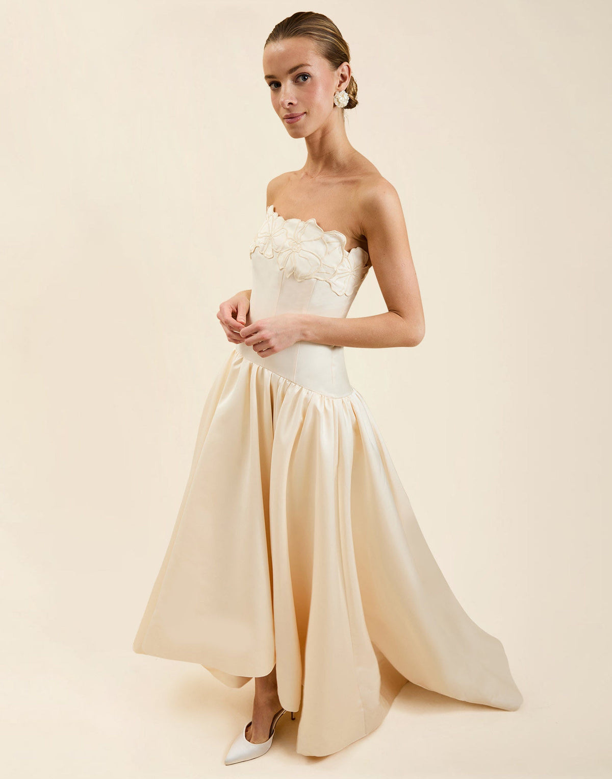 Nereida Dropwaist Gown in Ivory taffeta with strapless neckline, tonal floral embroidery, drop-waist silhouette, and high-low skirt with train.