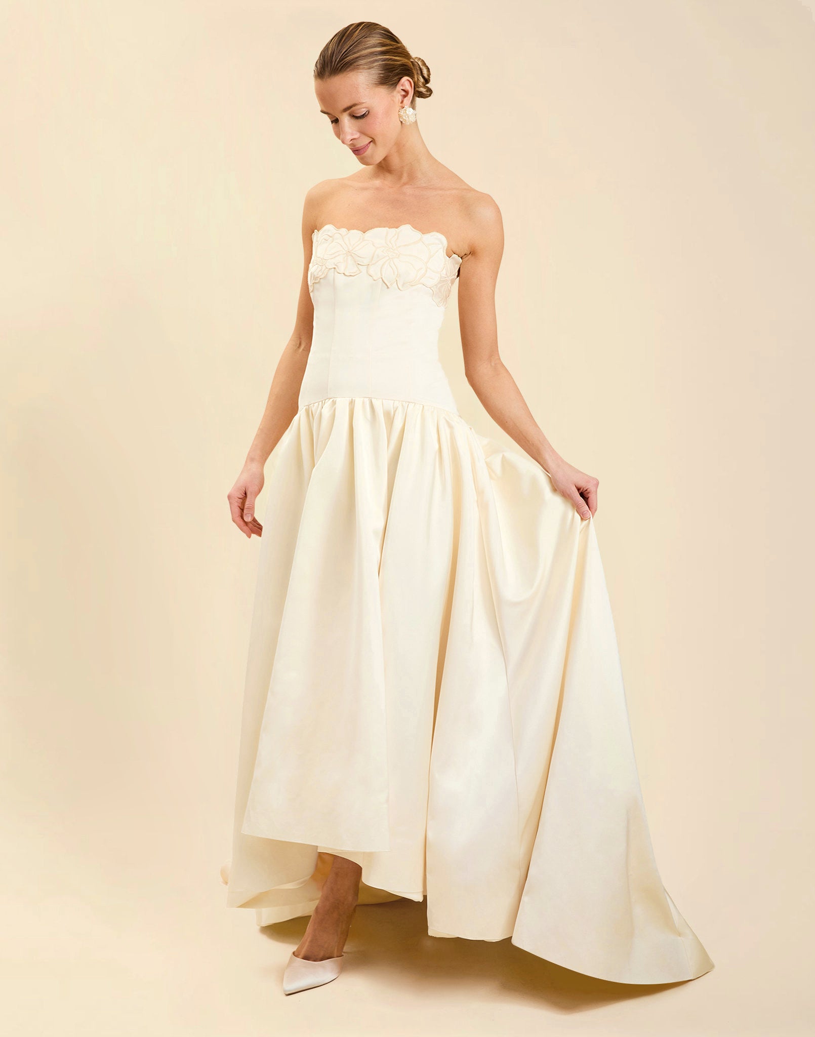 Nereida Dropwaist Gown in Ivory taffeta with strapless neckline, tonal floral embroidery, drop-waist silhouette, and high-low skirt with train.
