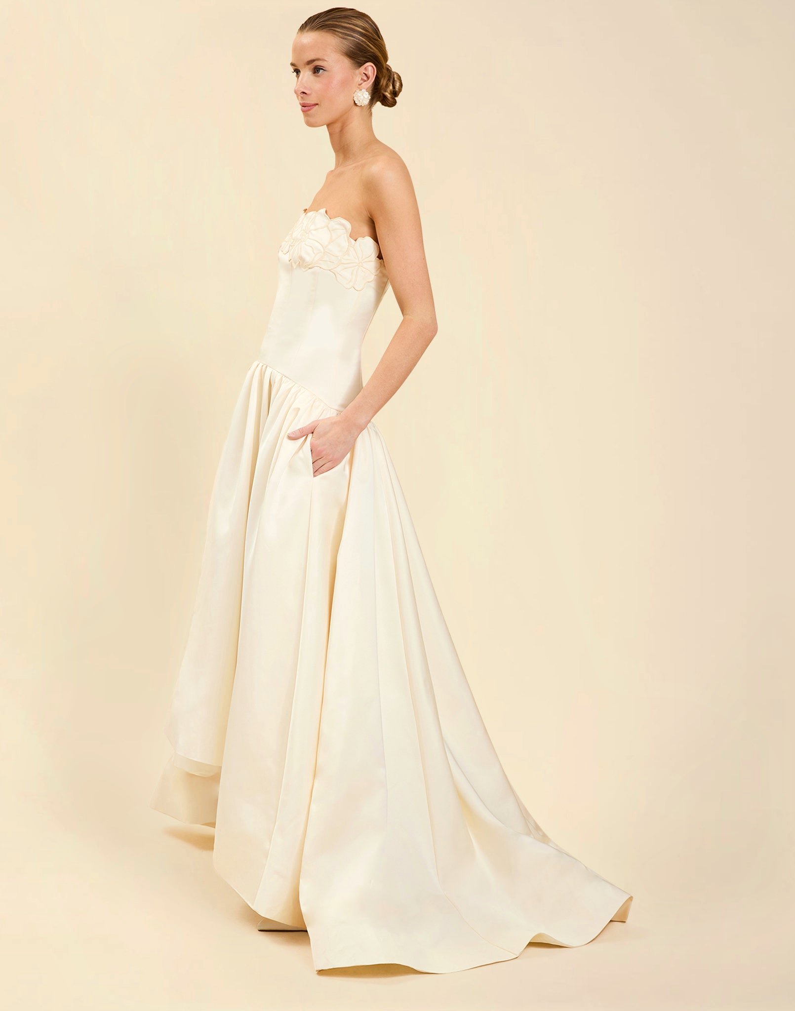 Nereida Dropwaist Gown in Ivory taffeta with strapless neckline, tonal floral embroidery, drop-waist silhouette, and high-low skirt with train.