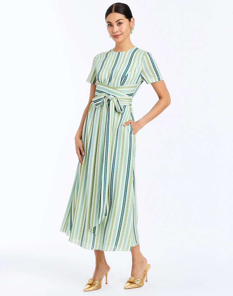 Side - Nolita Wrap Dress in Catena Stripe cocktail midi with faux wrap waist, gold hardware, and short sleeves.