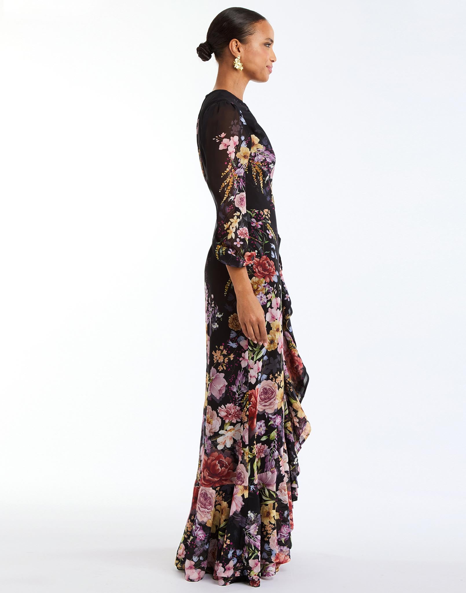 Ophelia Chiffon Gown in Twilight Florals side – chiffon evening gown with twisted keyhole neckline, sheer balloon sleeves, and cascading ruffle skirt by Mestiza New York.
