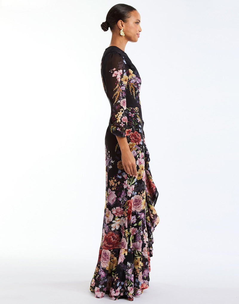 Ophelia Chiffon Gown in Twilight Florals side – chiffon evening gown with twisted keyhole neckline, sheer balloon sleeves, and cascading ruffle skirt by Mestiza New York.