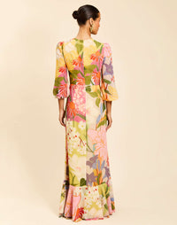 Ophelia Gown in Primrose Midnight chiffon with twisted keyhole neckline, cascading ruffle skirt, balloon sleeves, and leg slit.