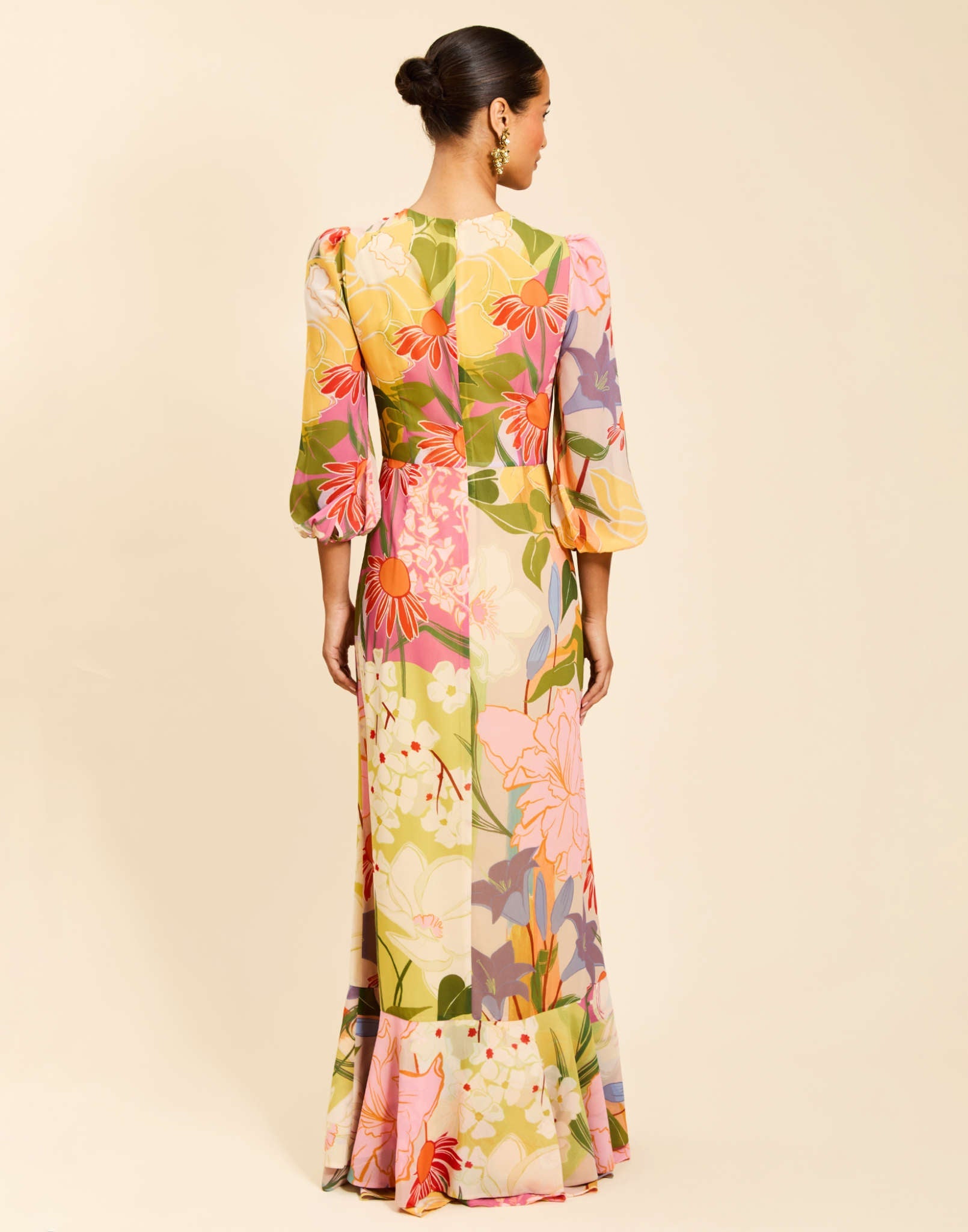 Ophelia Gown in Primrose Midnight chiffon with twisted keyhole neckline, cascading ruffle skirt, balloon sleeves, and leg slit.