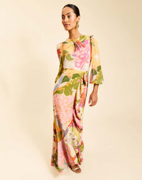 Ophelia Gown in Primrose Midnight chiffon with twisted keyhole neckline, cascading ruffle skirt, balloon sleeves, and leg slit.