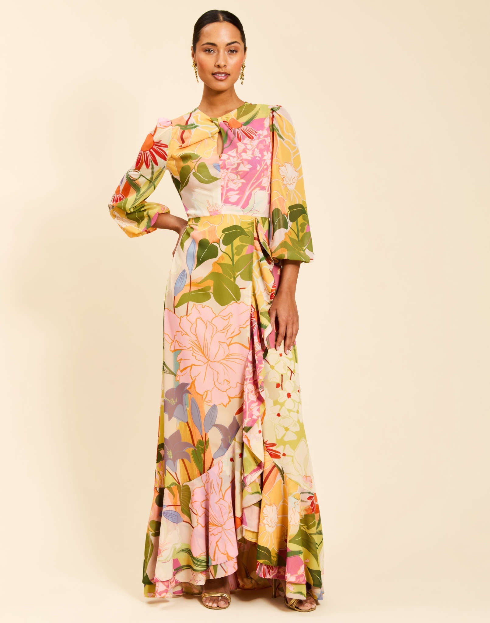 Ophelia Gown in Primrose Midnight chiffon with twisted keyhole neckline, cascading ruffle skirt, balloon sleeves, and leg slit.