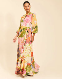 Ophelia Gown in Primrose Midnight chiffon with twisted keyhole neckline, cascading ruffle skirt, balloon sleeves, and leg slit.