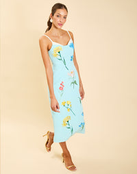 Pacifica Midi Dress in Blue Waltz moire with hand-sewn floral embroidery, peek-a-boo neckline, boned bodice, and side pockets.