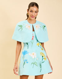 Samar Mini Dress in Blue Waltz moire with removable bow straps, floral embroidery, sweetheart neckline, and bell-shaped silhouette.