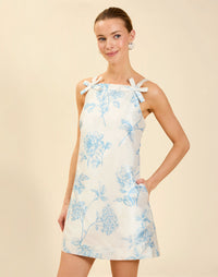 Payton Mini Dress in Powder Batiste poly dupioni with straight neckline, bow strap details, shift mini silhouette, and hidden side pockets.