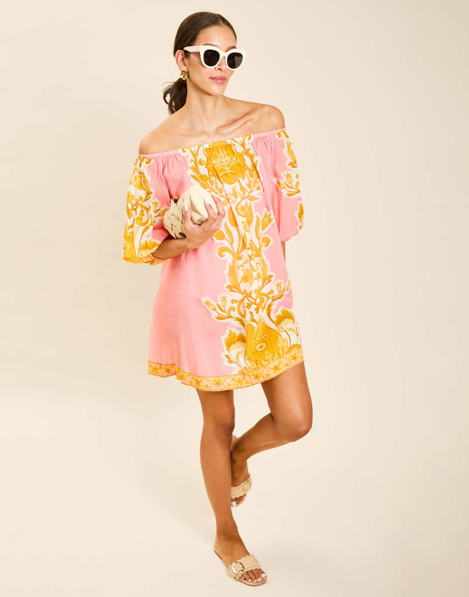 Model wearing Raffaella Mini Dress in Florentine Blush printed cotton voile with off-the-shoulder neckline and balloon sleeves.