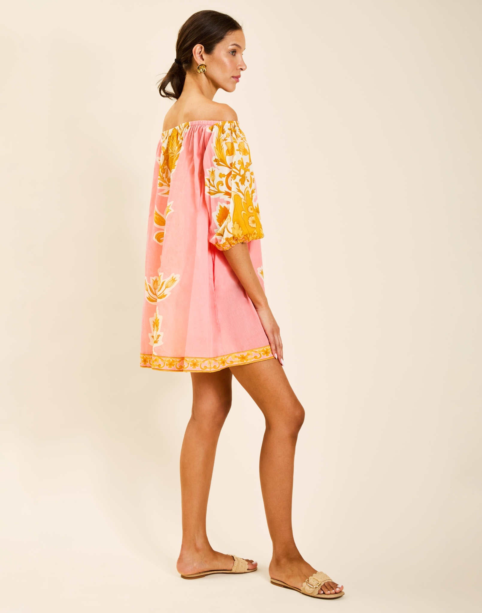 Model wearing Raffaella Mini Dress in Florentine Blush printed cotton voile with off-the-shoulder neckline and balloon sleeves.