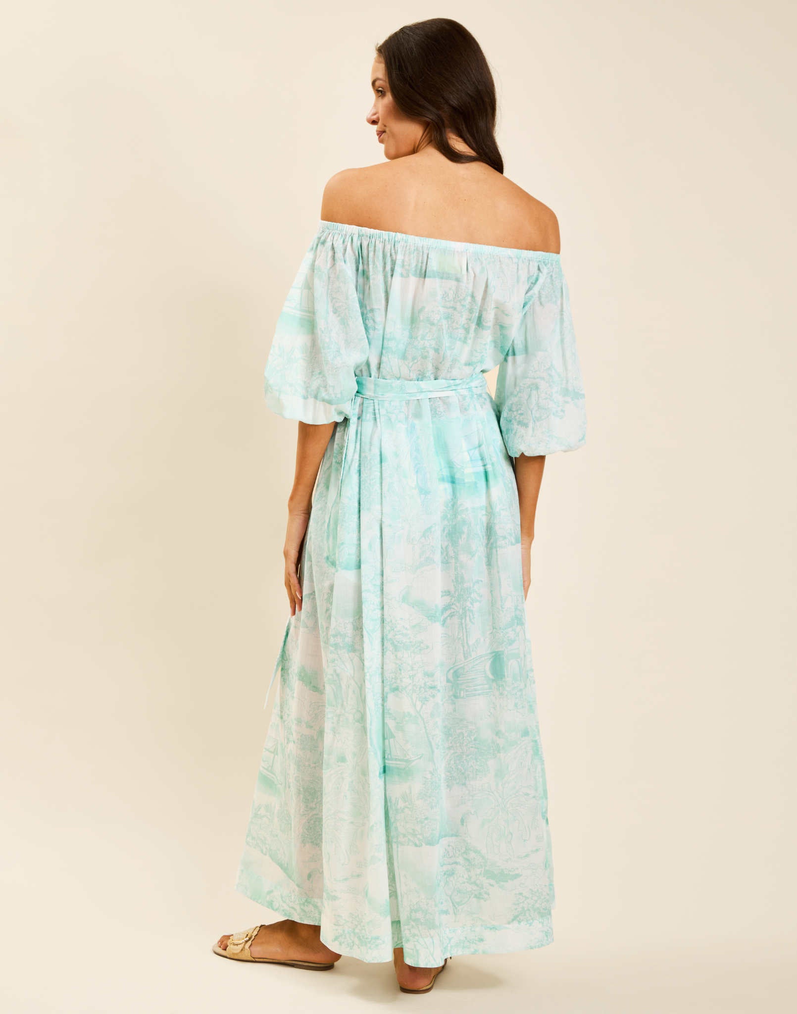 Model wearing Raffaella Midi Dress in Aegean Toile cotton voile with off-the-shoulder neckline and balloon sleeves.