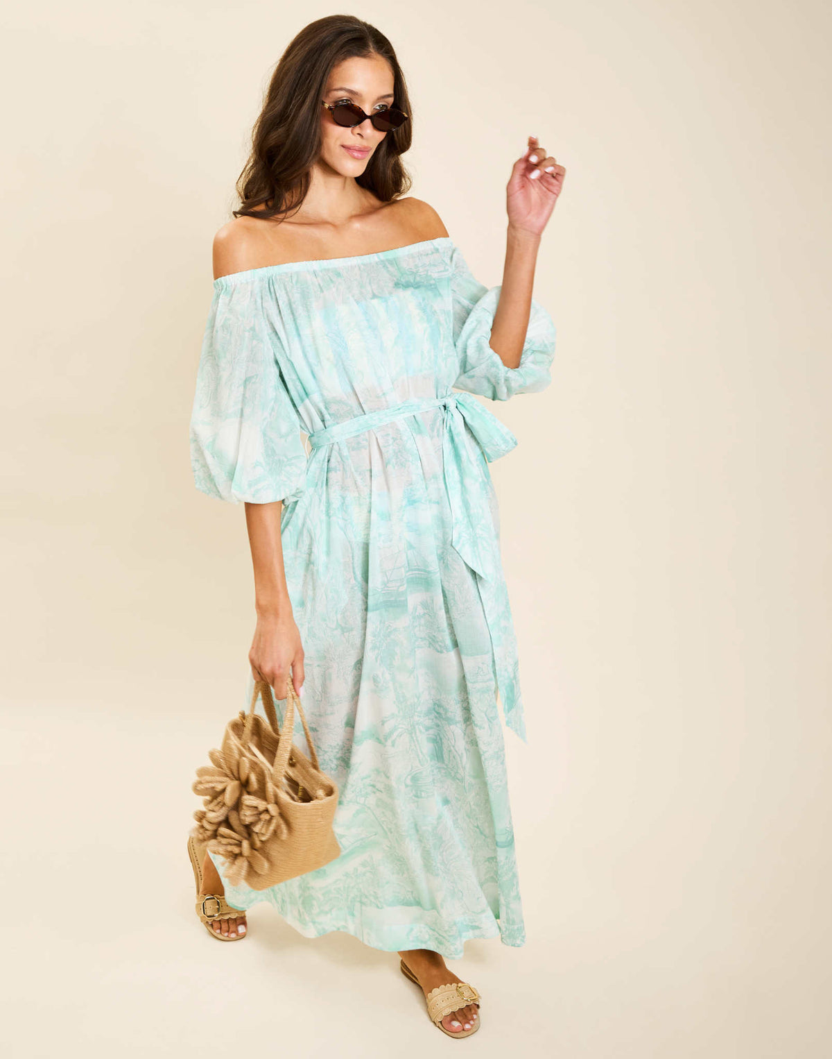 Model wearing Raffaella Midi Dress in Aegean Toile cotton voile with off-the-shoulder neckline and balloon sleeves.