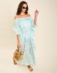 Model wearing Raffaella Midi Dress in Aegean Toile cotton voile with off-the-shoulder neckline and balloon sleeves.