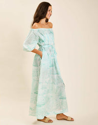 Model wearing Raffaella Midi Dress in Aegean Toile cotton voile with off-the-shoulder neckline and balloon sleeves.