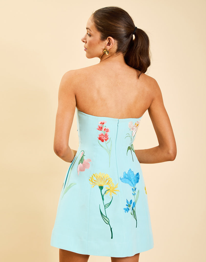 Samar Mini Dress in Blue Waltz moire with removable bow straps, floral embroidery, sweetheart neckline, and bell-shaped silhouette.