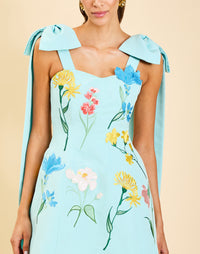 Samar Mini Dress in Blue Waltz moire with removable bow straps, floral embroidery, sweetheart neckline, and bell-shaped silhouette.