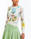 Cream crew neck sweater with colorful floral print. Ribbed collar cuffs and hem. 