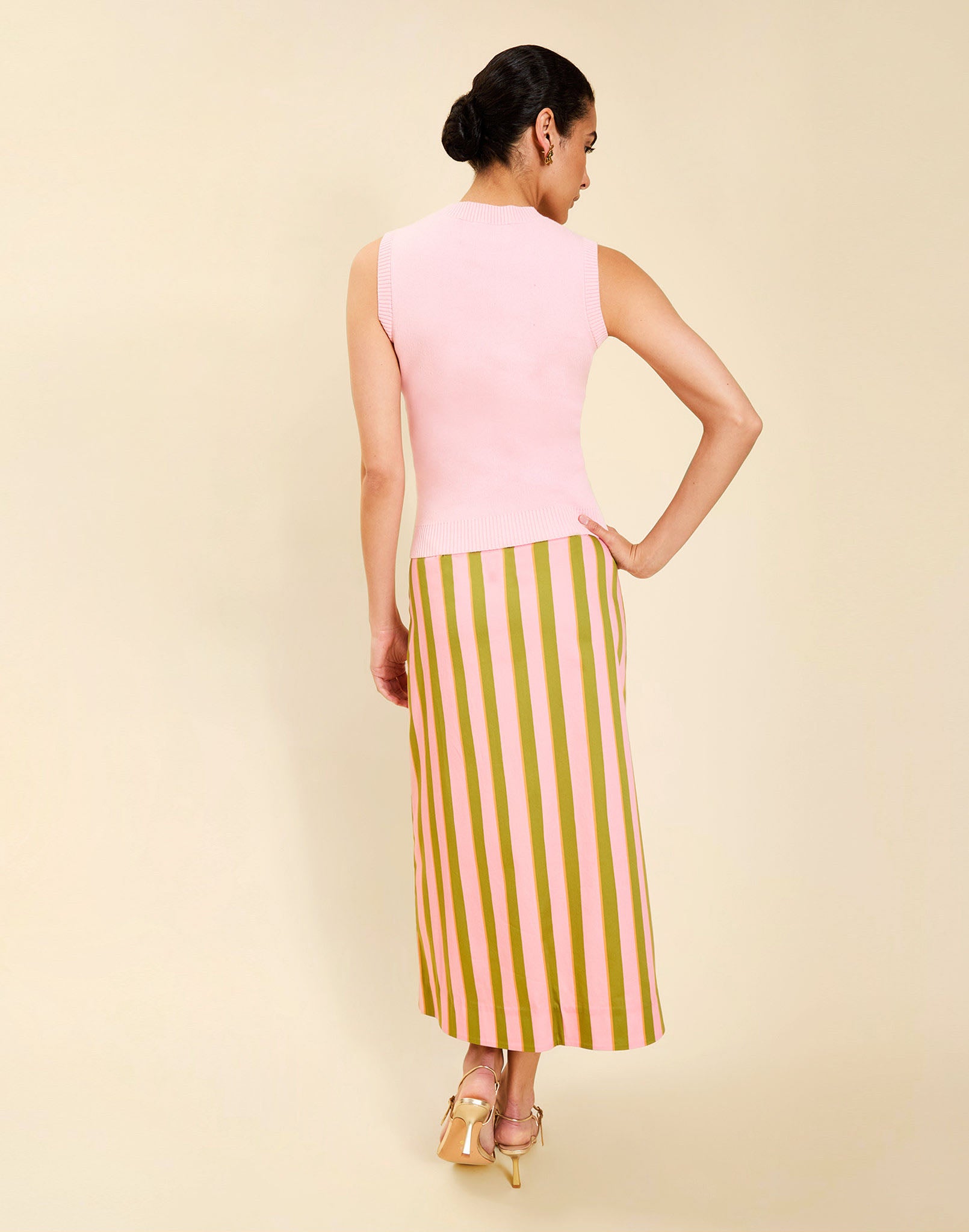 Woman wearing the Mestiza Soho Knit Shell Top in English Rose, featuring a sleeveless silhouette, crew neckline, ribbed trim, cropped fit, and soft knit fabrication.