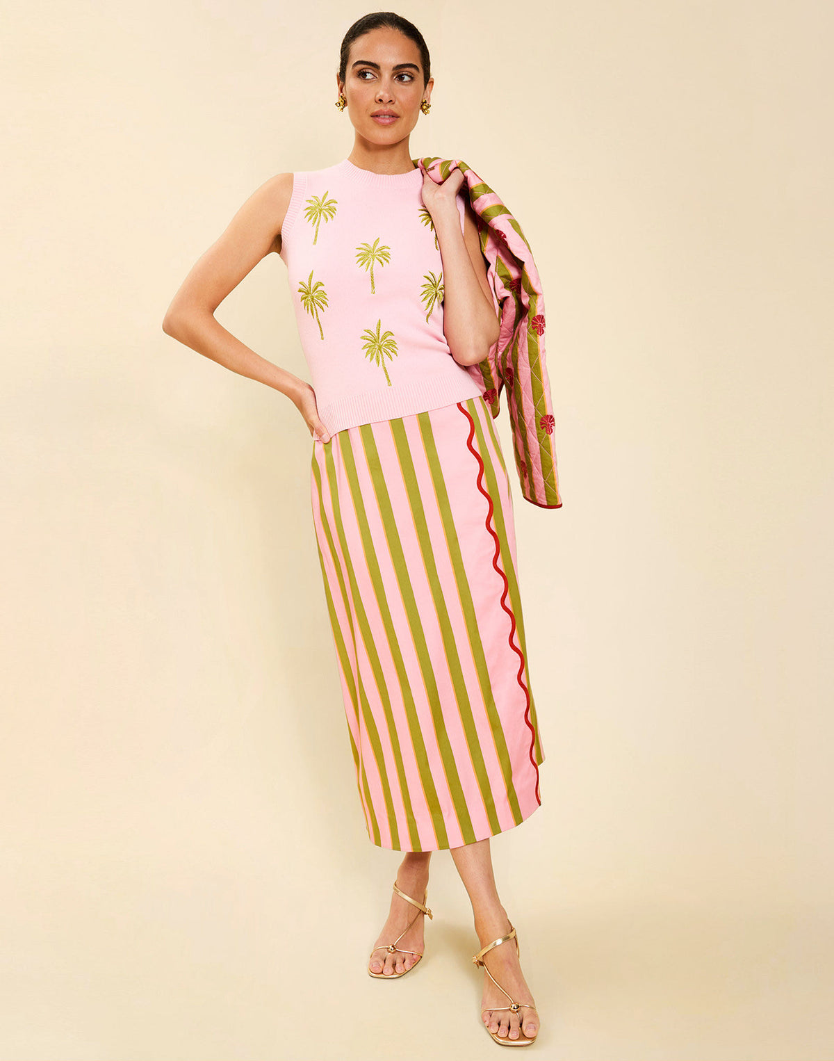Woman wearing the Mestiza Joyah Midi Skirt in Herbes de Provence print, featuring a wrap-style silhouette, A-line shape, scalloped trim detailing, and cotton poplin fabrication.