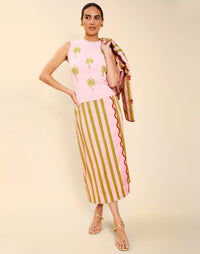Woman wearing the Mestiza Joyah Midi Skirt in Herbes de Provence print, featuring a wrap-style silhouette, A-line shape, scalloped trim detailing, and cotton poplin fabrication.