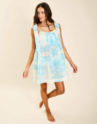 Model wearing Solenn Mini Dress in Aegean Flourish cotton voile with straight neckline and relaxed silhouette.
