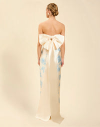 Solstice Gown in Powder Batiste poly silk twill with strapless neckline, removable pleated band, statement bow detail, and fitted gown silhouette.