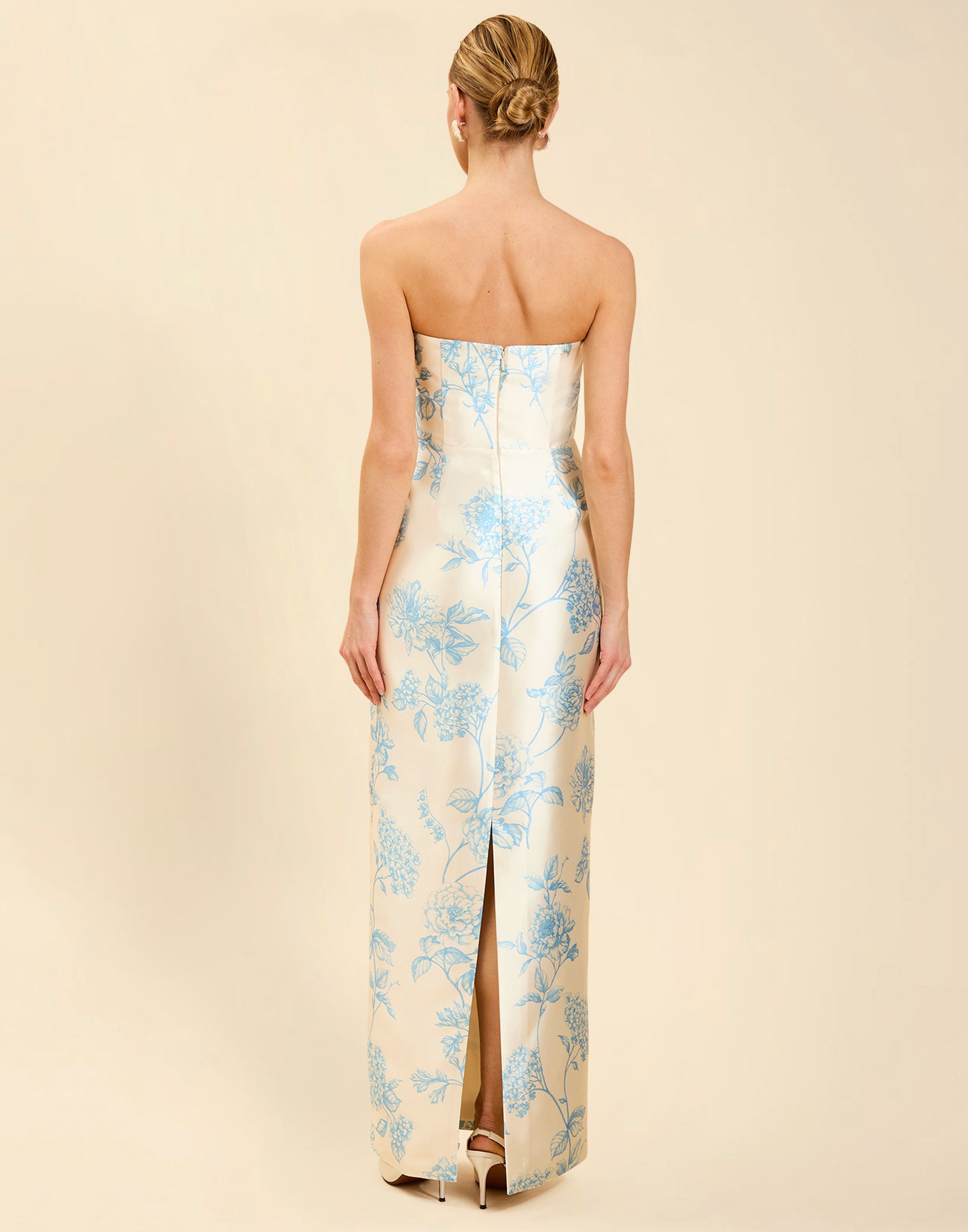 Solstice Gown in Powder Batiste poly silk twill with strapless neckline, removable pleated band, statement bow detail, and fitted gown silhouette.