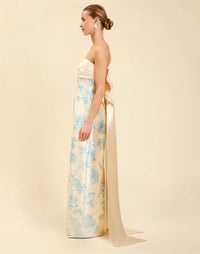 Solstice Gown in Powder Batiste poly silk twill with strapless neckline, removable pleated band, statement bow detail, and fitted gown silhouette.