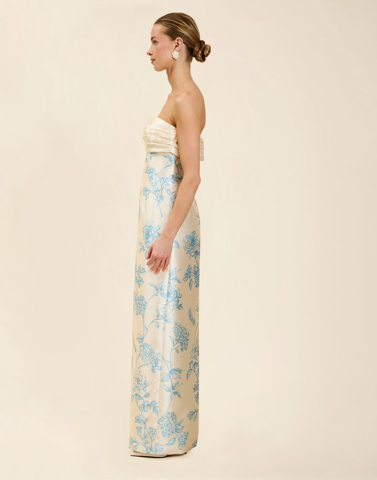Solstice Gown in Powder Batiste poly silk twill with strapless neckline, removable pleated band, statement bow detail, and fitted gown silhouette.

