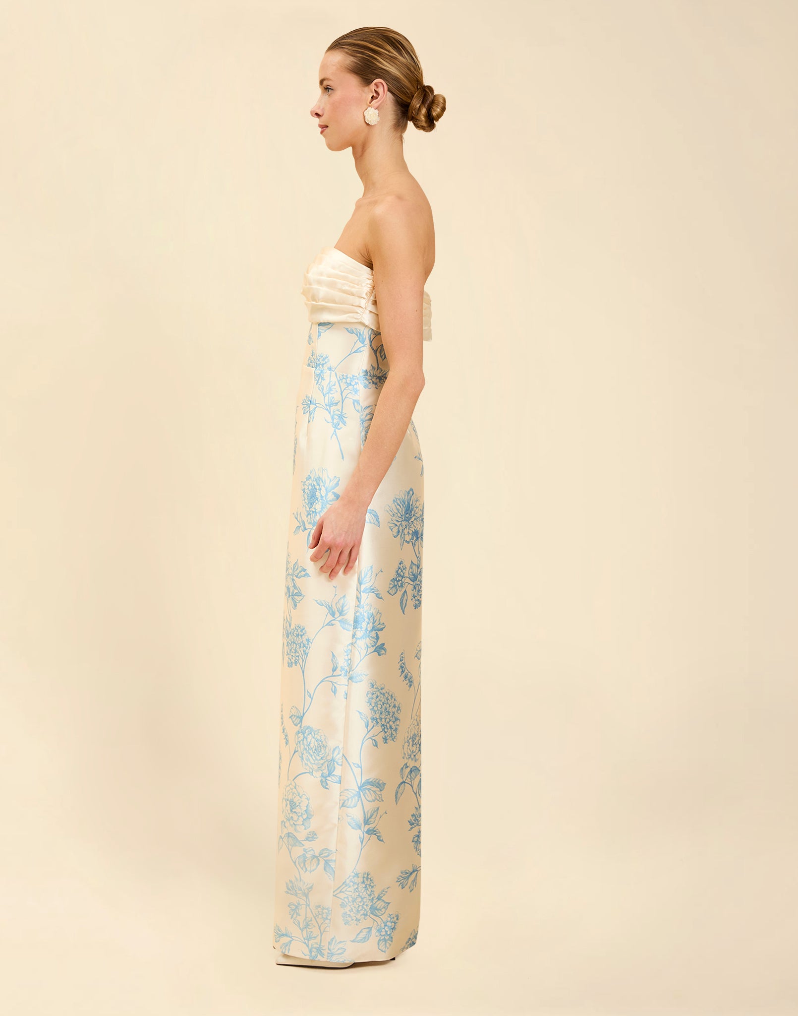 Solstice Gown in Powder Batiste poly silk twill with strapless neckline, removable pleated band, statement bow detail, and fitted gown silhouette.