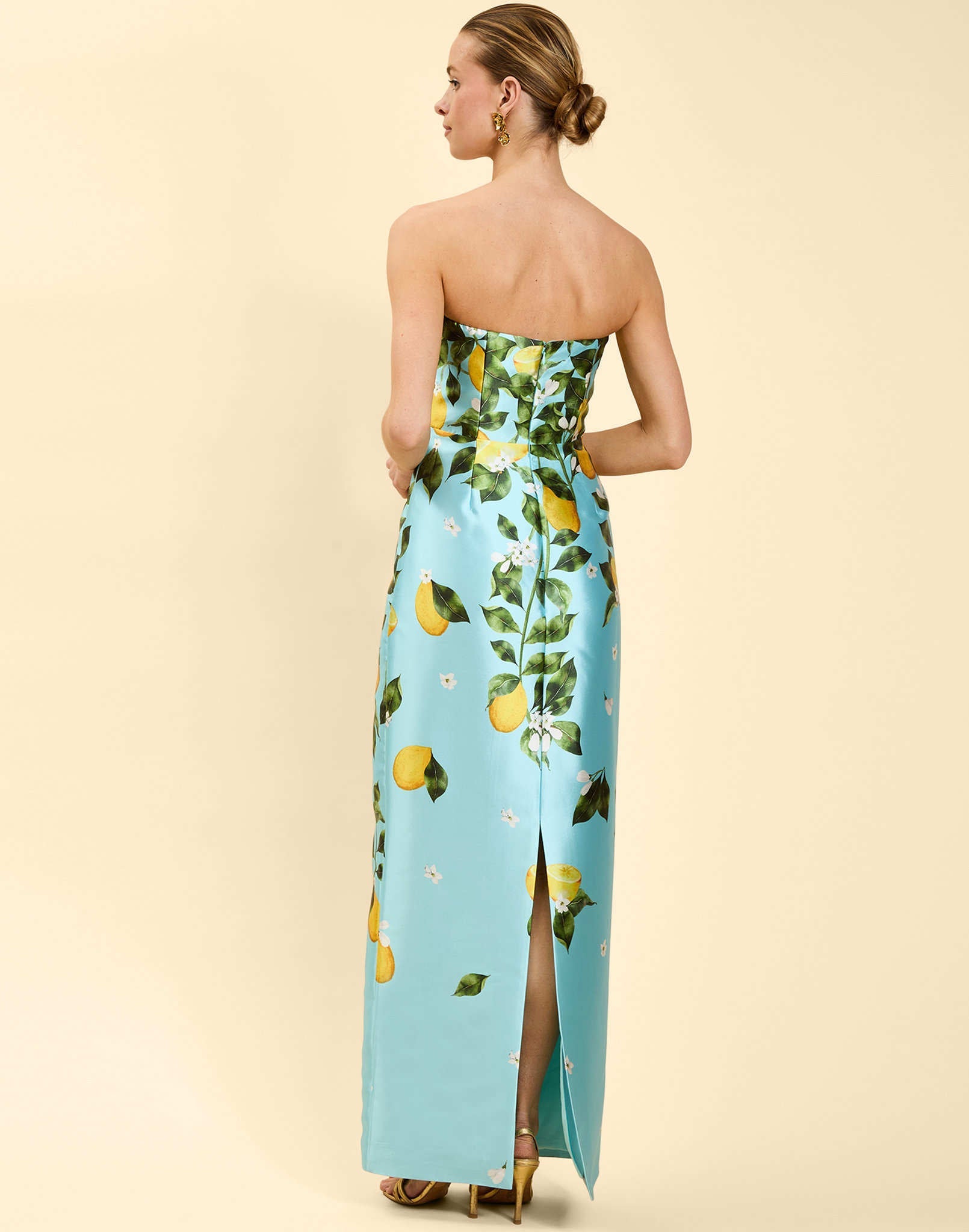 Solstice Gown in Sorrento Citrus poly silk twill with strapless neckline, removable bow, convertible bodice, and side pockets.