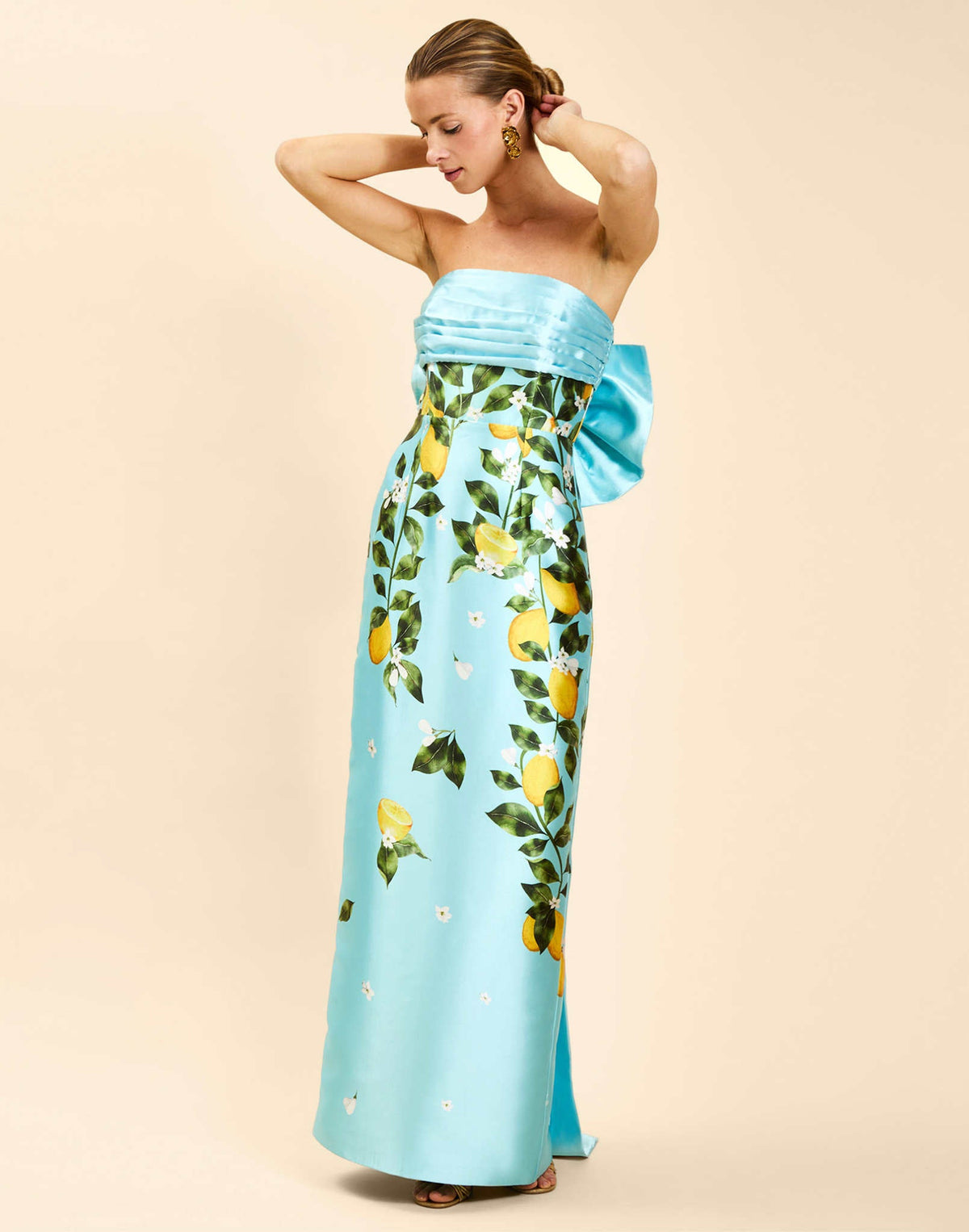 Solstice Gown in Sorrento Citrus poly silk twill with strapless neckline, removable bow, convertible bodice, and side pockets.