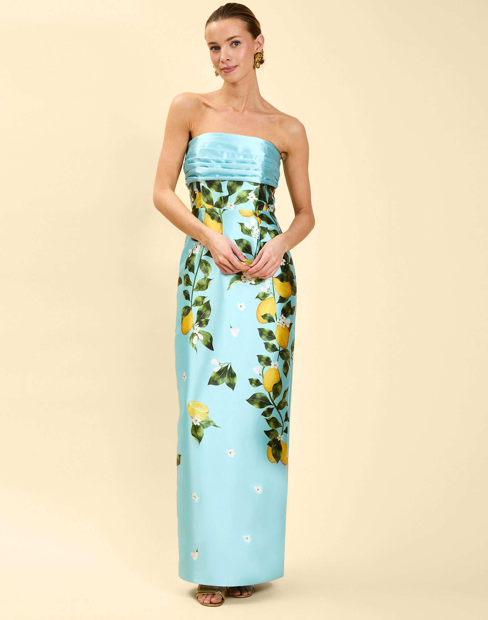 Solstice Gown in Sorrento Citrus poly silk twill with strapless neckline, removable bow, convertible bodice, and side pockets.