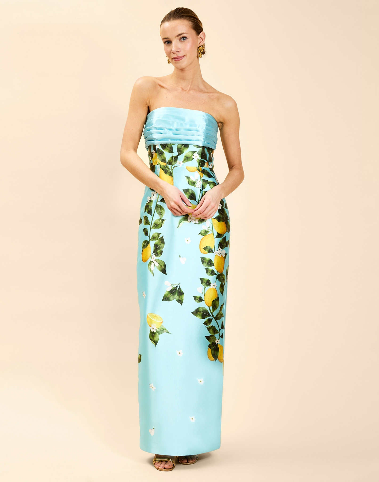 Solstice Gown in Sorrento Citrus poly silk twill with strapless neckline, removable bow, convertible bodice, and side pockets.